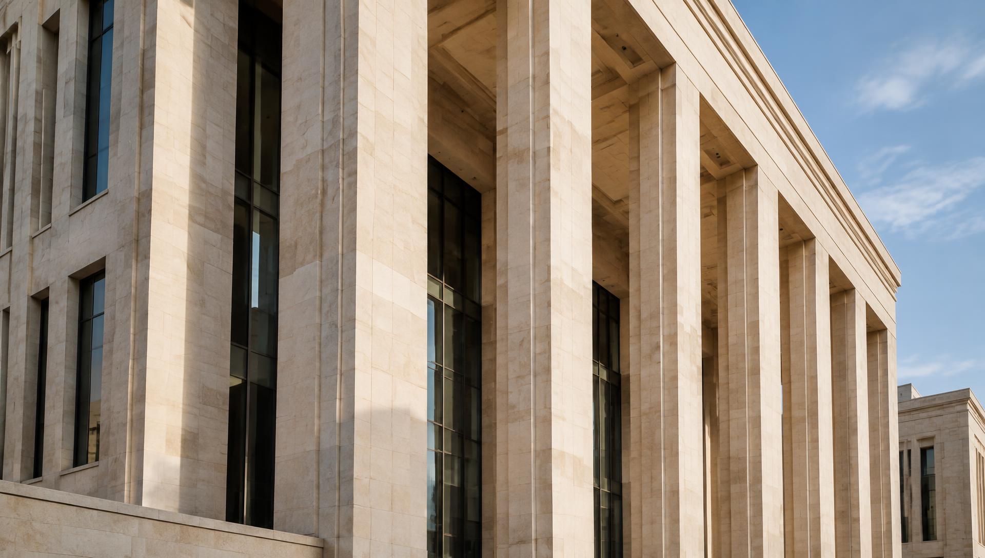 Sunlit stone columns and a contemporary civic facade